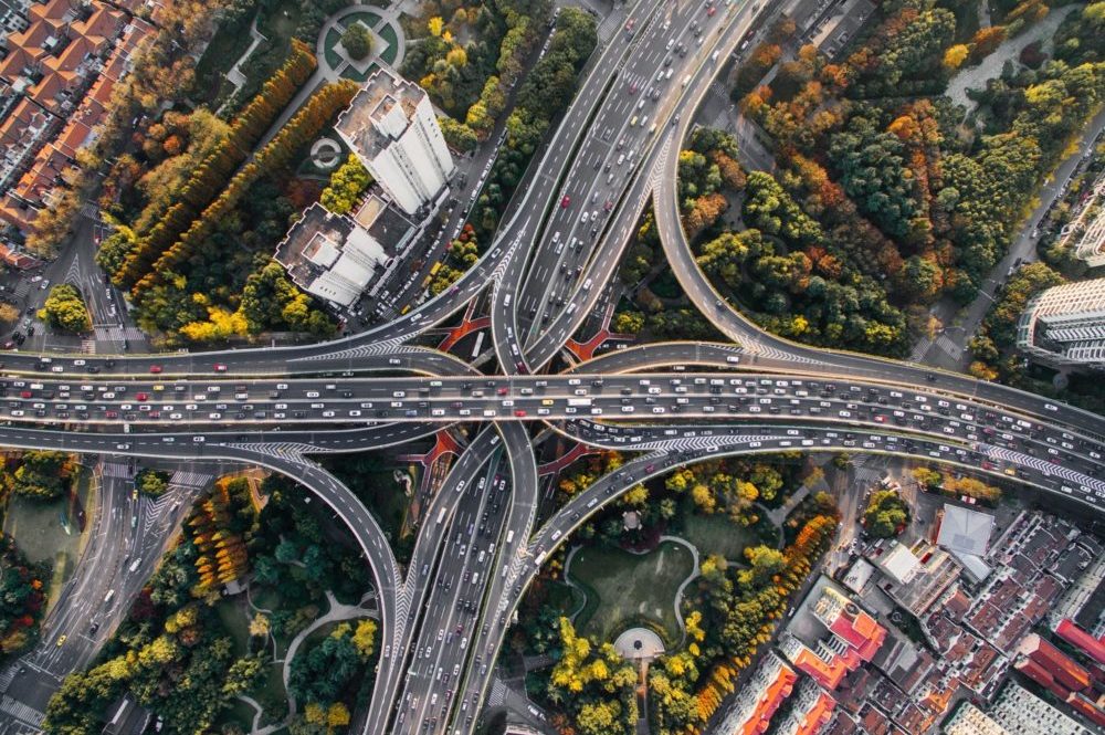 drone view of intersecting highways during fall time