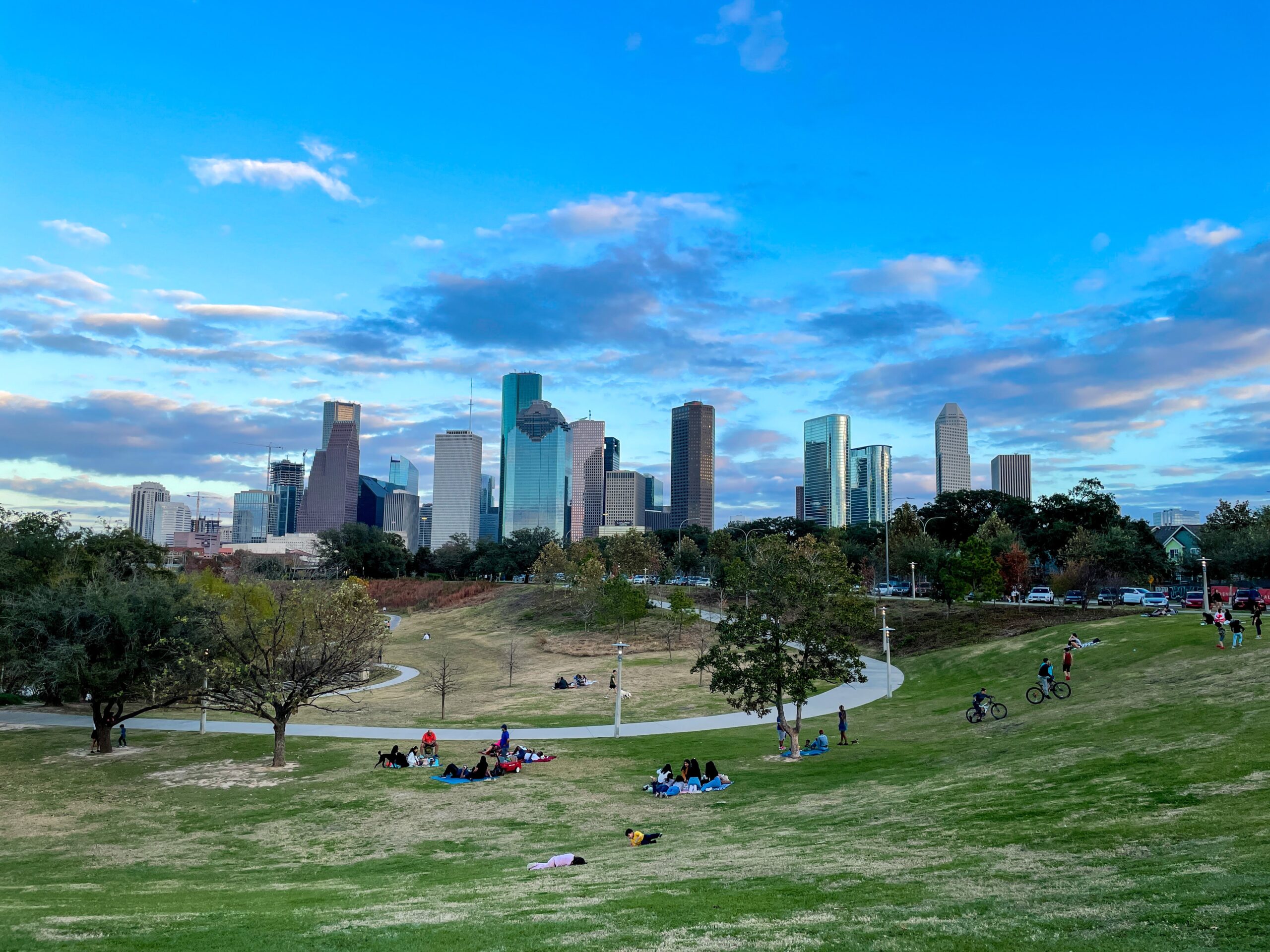 Aerial view of cityscape and people sitting around a large park in Houston Texas