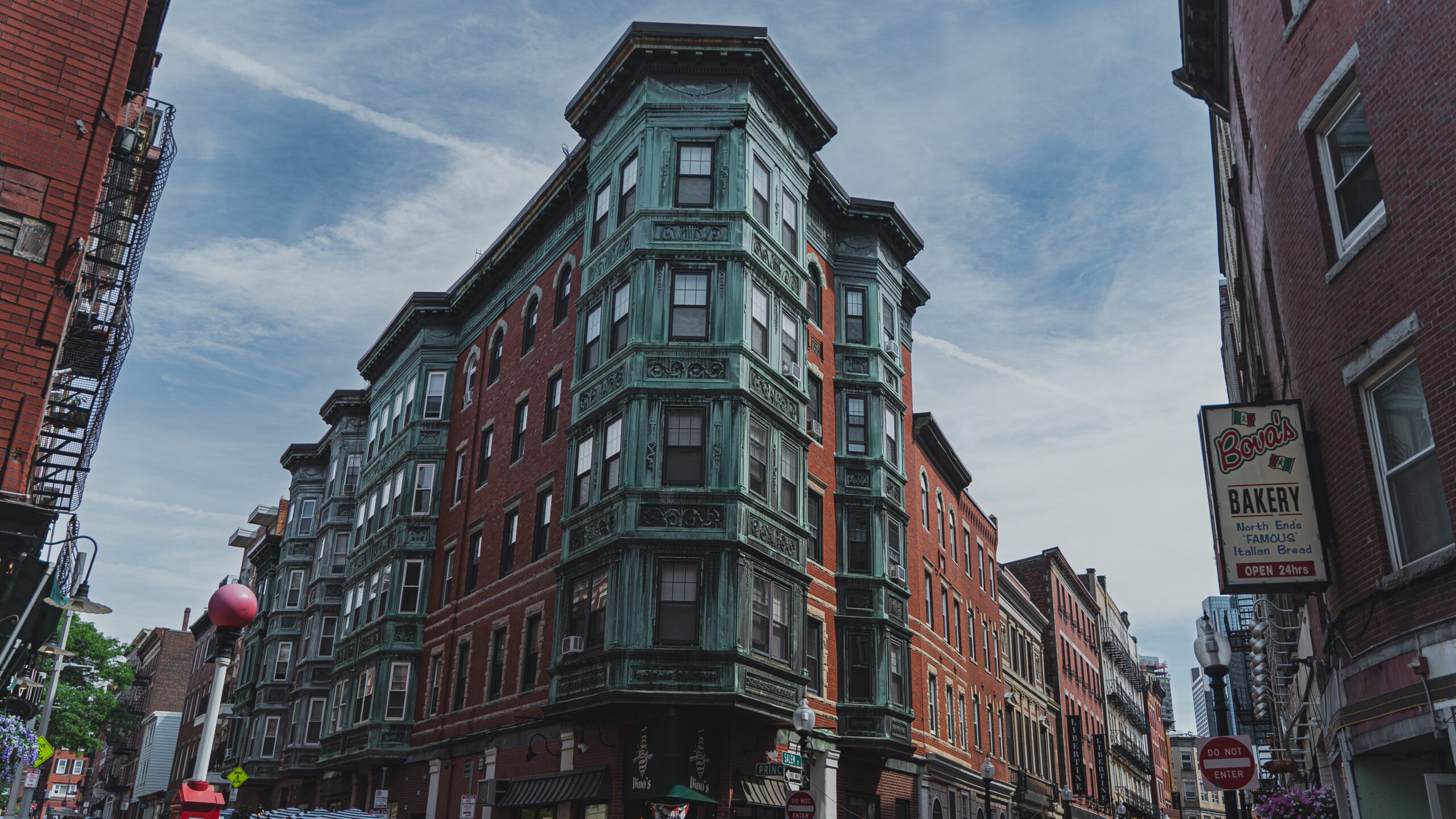 Corner of Brownstone building in North End Boston next to Bava's Bakery shop