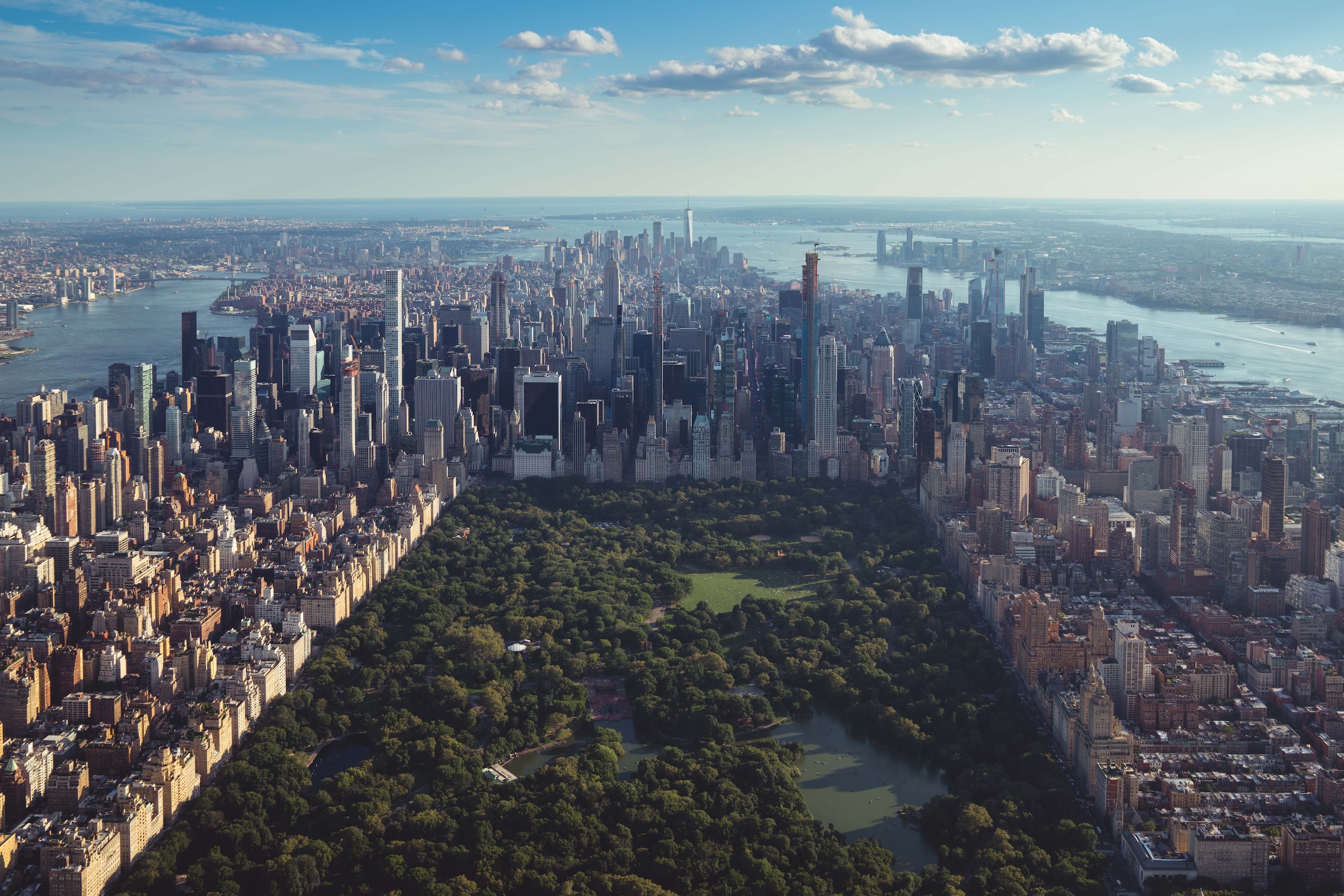 Aerial view of Central Park in New York City surrounded by buildings and tall skyscrappers