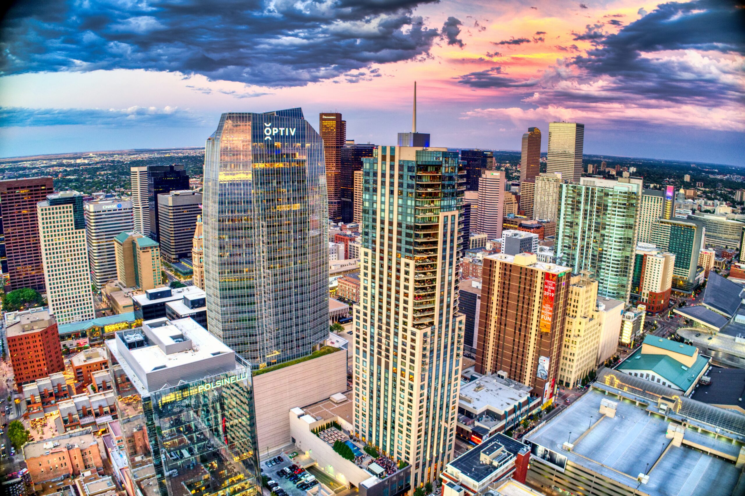 Aerial shot of tall commercial buildings in Downtown Denver West during Golden Hour