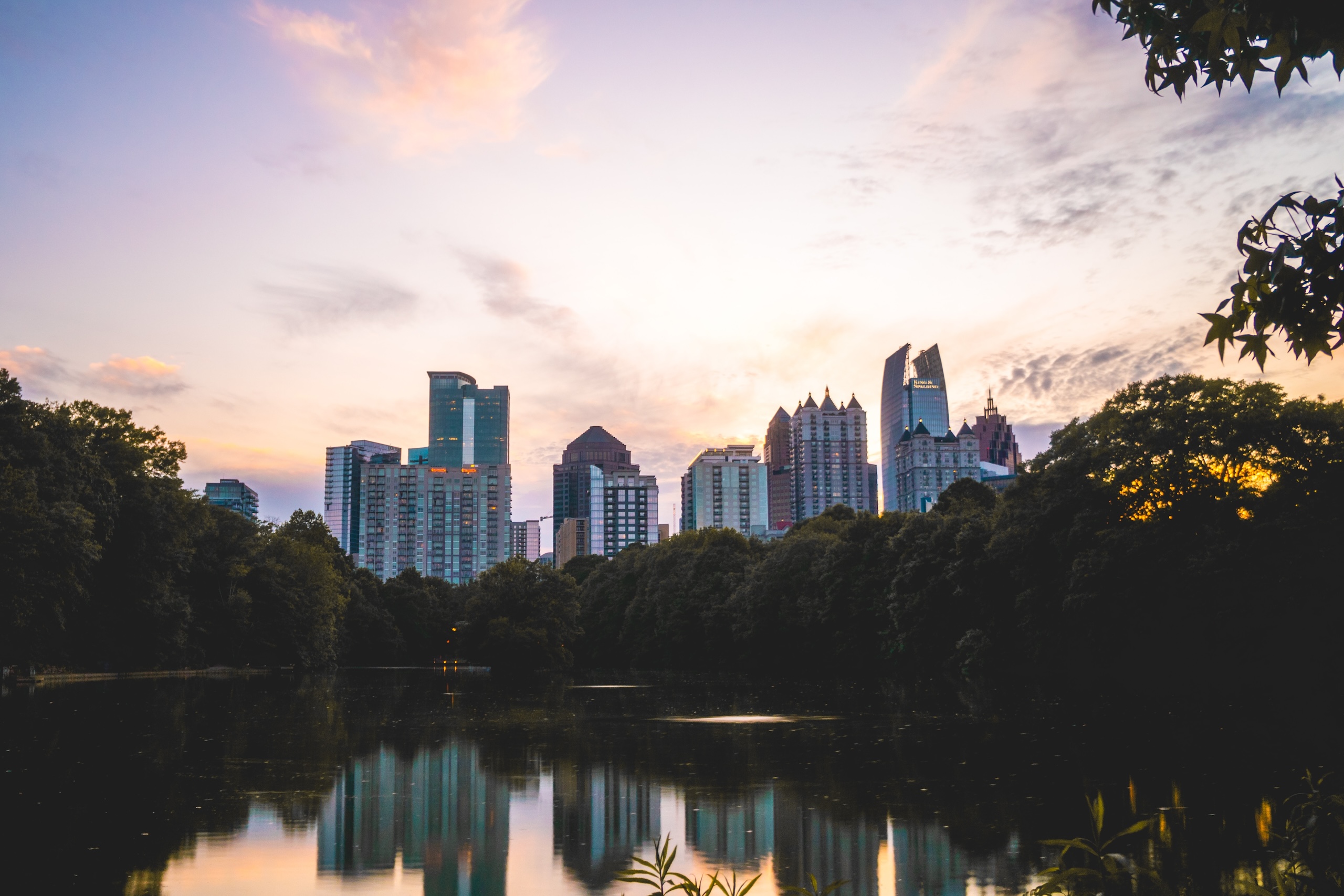 sunset in Piedmont Park in Atlanta with building backdrop