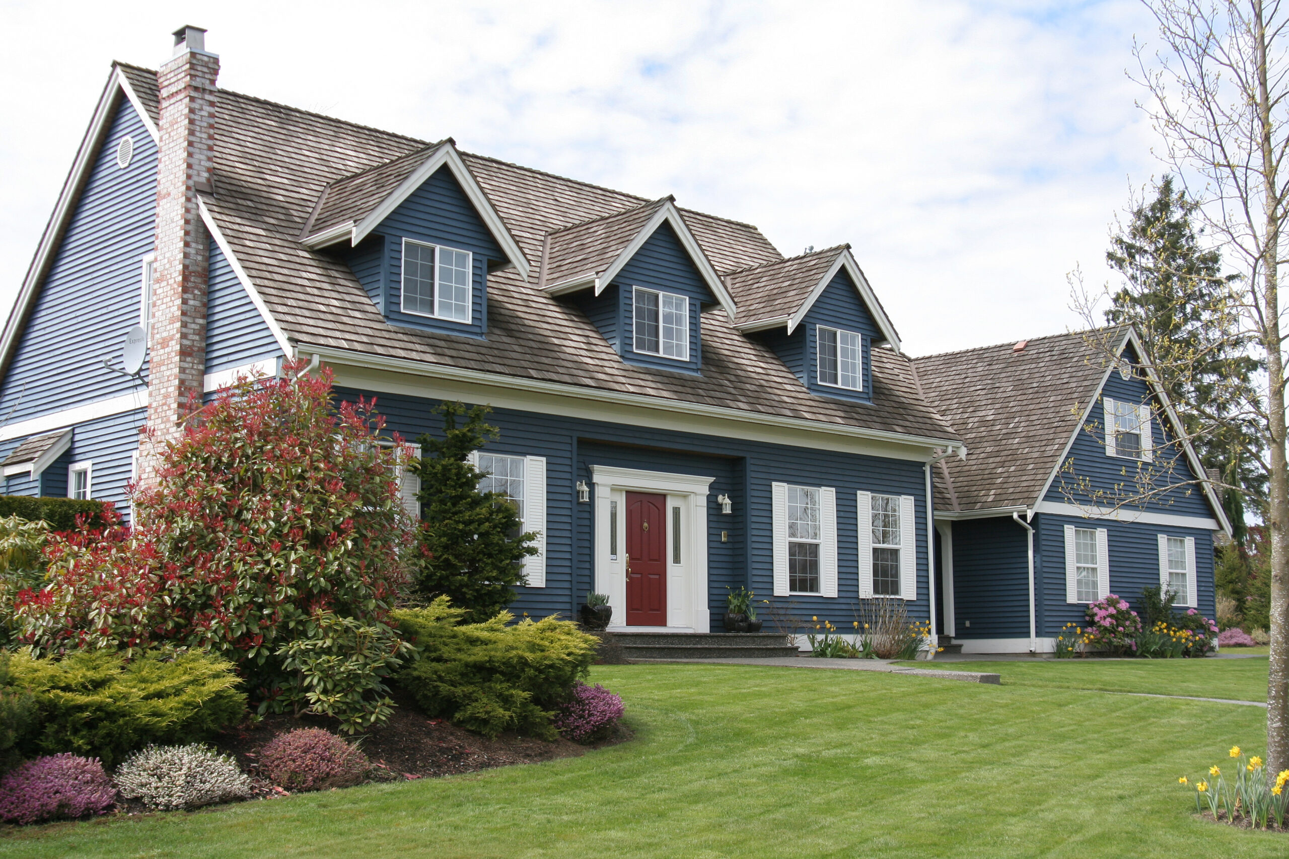 Two-floor home in a residential area adorned with a large front lawn