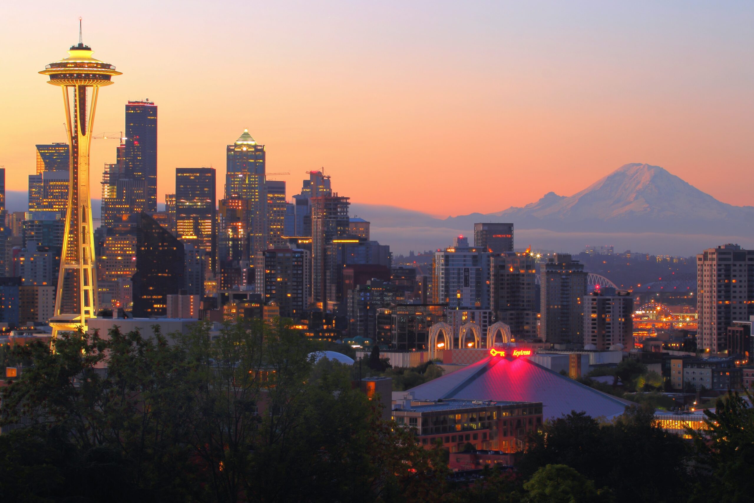 View of The Needle in Seattle at dawn with mountains as a backdrop